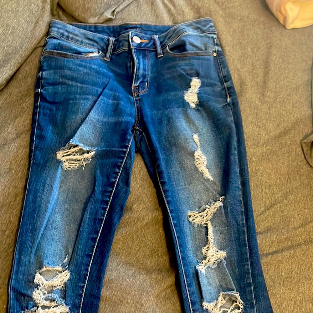 Slightly worn blue ripped jeans
